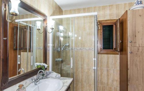 a bathroom with a shower and a sink and a mirror at Cozy Home In Inca With Outdoor Swimming Pool in Inca