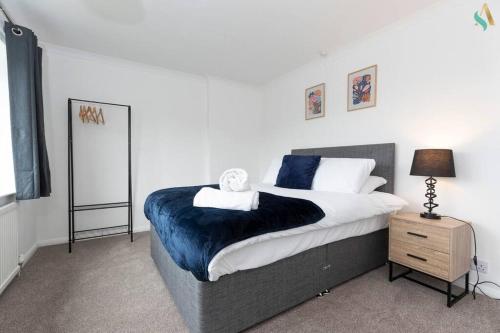 a bedroom with a large bed and a night stand at Gilside Lodge in Stockton-on-Tees