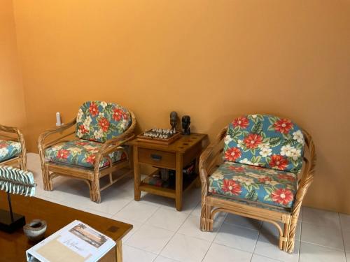 a living room with two chairs and a table at Taste Of Freedom in Brighton Village