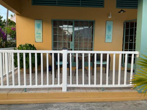 a white fence on the front of a house at Taste Of Freedom in Brighton Village
