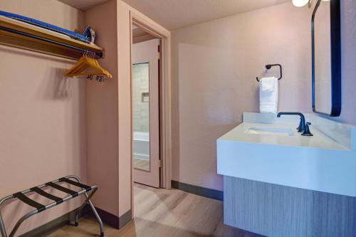 a bathroom with a sink and a mirror at The Dunes Hotel (Palm Springs) in Palm Springs