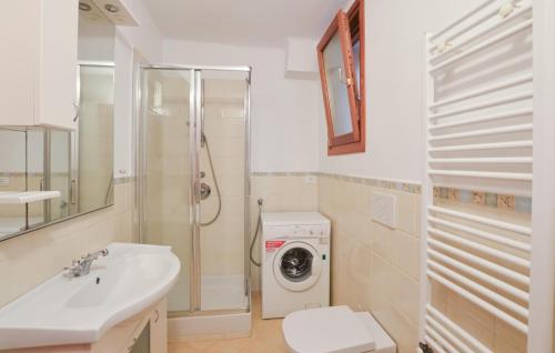 a bathroom with a sink and a washing machine at 1 Bedroom Cozy Apartment In Reggimonti in Reggimonti