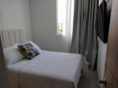 a bedroom with a bed with a pillow on it at HABITACION NOVA CONDOMINIO PLUS CALI in Cali