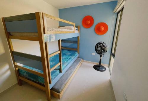 a room with two bunk beds and a fan at The Refuge#1 Lovely 2 BR-Apt pool & good vibes in Santa Marta