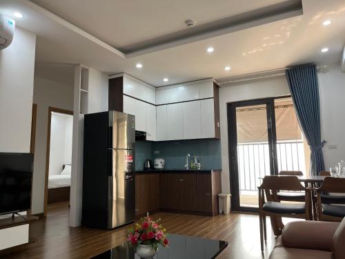 a kitchen with a stainless steel refrigerator in a room at Mami House - Tecco Elite City Thai Nguyen Serviced Apartments in Thái Nguyên