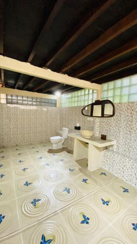 a bathroom with a toilet and a tile floor at Balangan Sea View Bungalow in Jimbaran