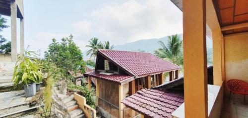 a small house with a red roof at Aman's Guesthouse in Tuktuk Siadong