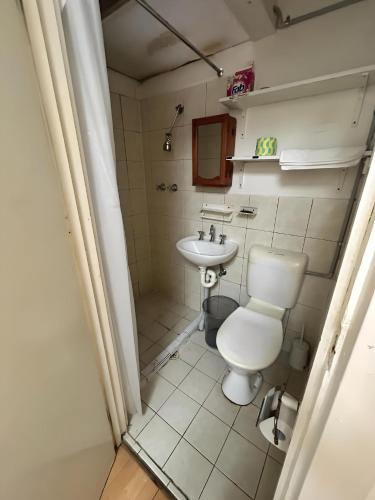 a small bathroom with a toilet and a sink at Studio 9 - Wright Lodge in Adelaide