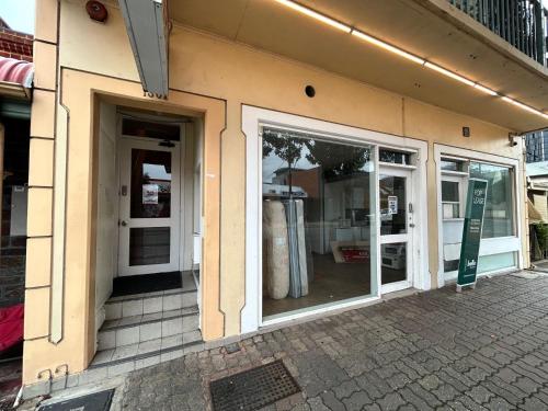 a store front with glass doors on a building at Studio B - Wright Lodge in Adelaide