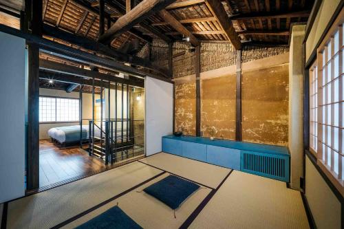 an empty room with a bed in a room at Asagi an Machiya House in Kyoto