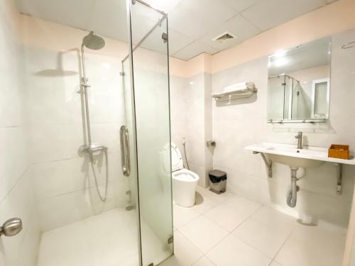 a bathroom with a shower and a sink and a toilet at Ngọc Hân Hotel By The Moment in Vung Tau