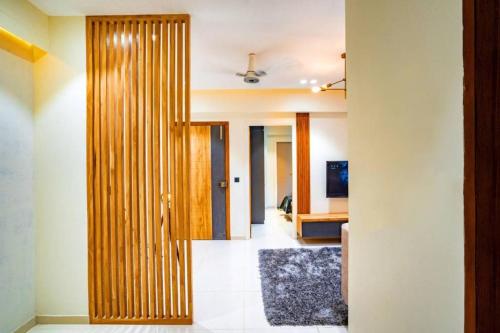 a hallway with a wooden door in a room at Swati Homestays in Ahmedabad