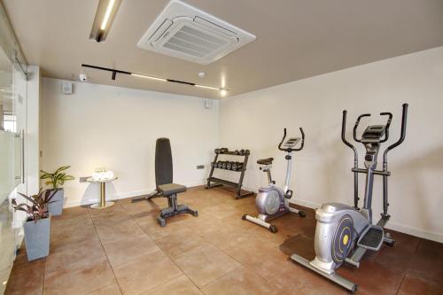 a gym with exercise equipment in a room at Saltstayz Premier - Near Golf Course Road & Sector 57 in Gurgaon