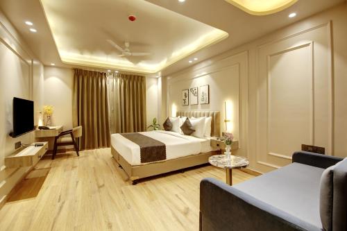 a hotel room with a bed and a couch at Saltstayz Premier - Near Golf Course Road & Sector 57 in Gurgaon