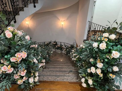 a stairway with pink and white flowers at DeGarden House Klang in Klang