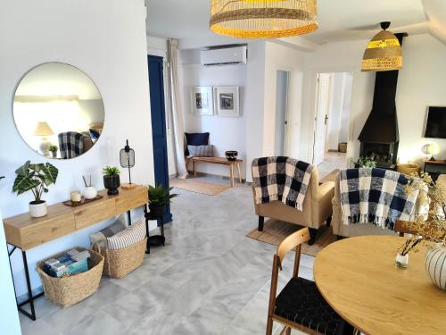 a living room with a table and chairs at Evans Realty AT Ático & Centro & Playa & Vistas mar in Fuengirola