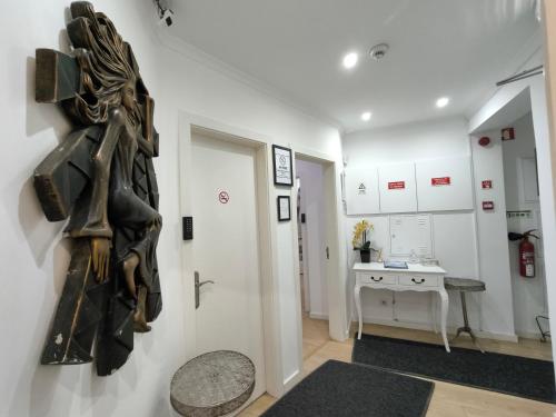 a room with a statue of a person on a wall at Lisbon Terrace Suites Special for Groups up to 19 guests in Lisbon