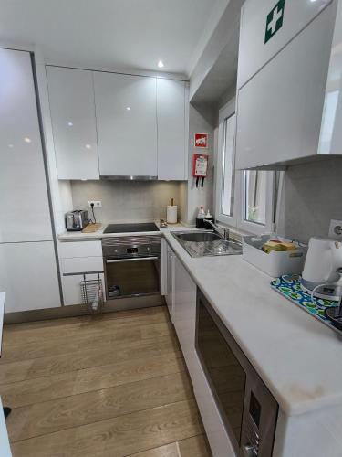 a kitchen with white cabinets and a counter top at Lisbon Terrace Suites Special for Groups up to 19 guests in Lisbon