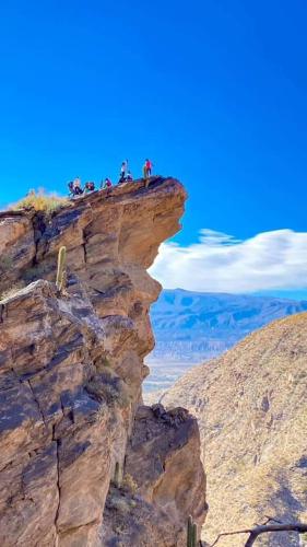 a group of people standing on top of a cliff at Río de Chocolate in Santa María