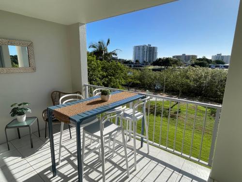 a blue table and chairs on a balcony with a view at City Riverside Apartment 25 in Townsville