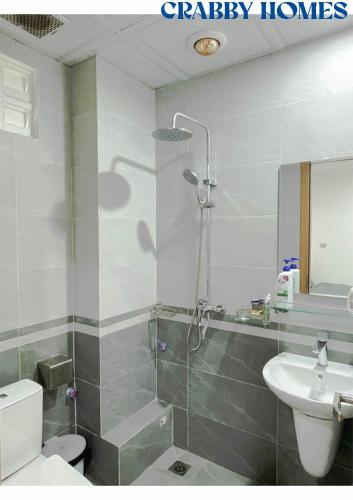 a bathroom with a shower and a toilet and a sink at Crabby homes in Hanoi
