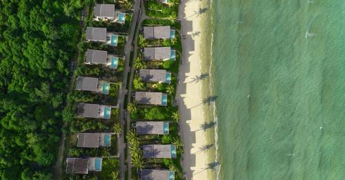 an overhead view of a group of houses next to the beach at Six Senses Con Dao - Turtle Island Paradise in Con Dao