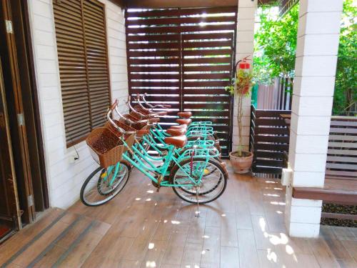 a group of bikes parked outside of a house at Thanicha Resort Amphawa in Amphawa