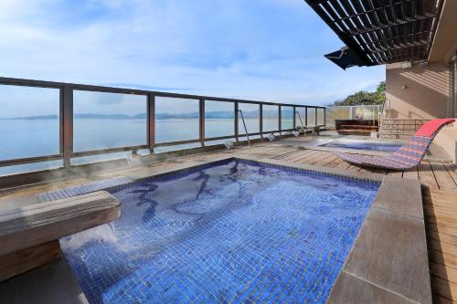 a swimming pool on the deck of a house at Ako Onsen Shokichi in Ako