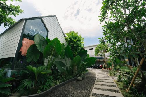 a building with a sign on the side of it at The Jungle Hostel Canggu in Canggu