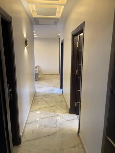 an empty hallway with a hallway leading into a room at Apartment in Luxor Resort, next to Raya Market in Nag` Naqsha