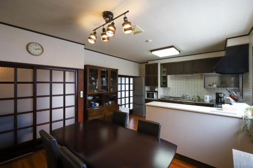 a kitchen and dining room with a table and chairs at 貸切民泊宿 だんねだんね Private guest house Danne-Danne in Ōno