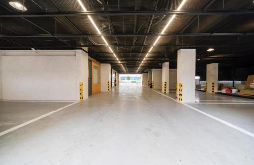 an empty room with a long hallway in a building at Gwanganli Calm Rest Hotel in Busan