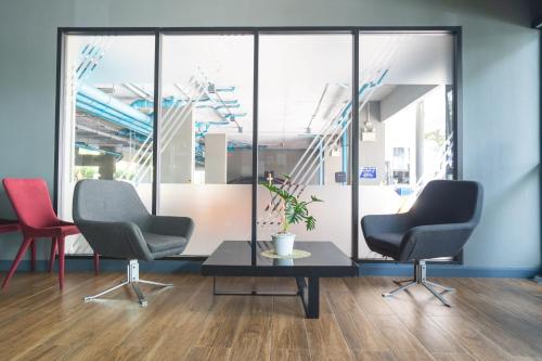 a waiting room with two chairs and a table at ZcapeX2 in Bang Tao Beach
