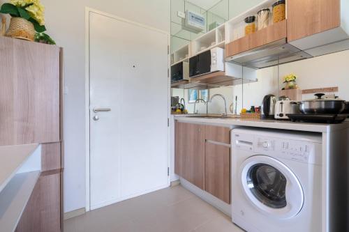 a kitchen with a washer and a washing machine at ZcapeX2 in Bang Tao Beach