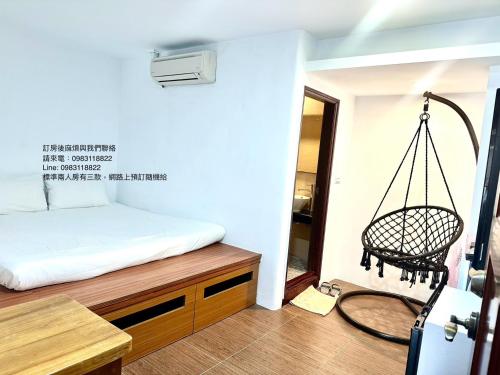 a room with a bed and a swing at Nanwan254 Homestay in Nanwan