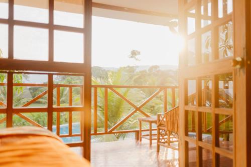 a room with a door open to a balcony with a view at Maloca Inn in Sauce