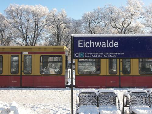 a sign in the snow next to a train at Port Inn Hotel in Eichwalde