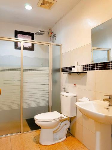 a bathroom with a toilet and a sink at Villa Marinelli Bed and Breakfast in Tagaytay