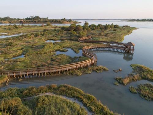 an aerial view of a wooden bridge over a river at Spacious apartment close to the beach - Beahost in Rosolina Mare