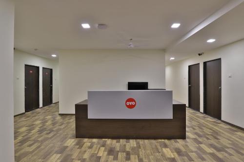 an office with a podium with a stop sign on it at Hotel O Ripple Mall in Surat