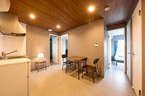 a kitchen and dining room with a table and chairs at Hotel CABANA カバナ 宮古島 in Miyako Island
