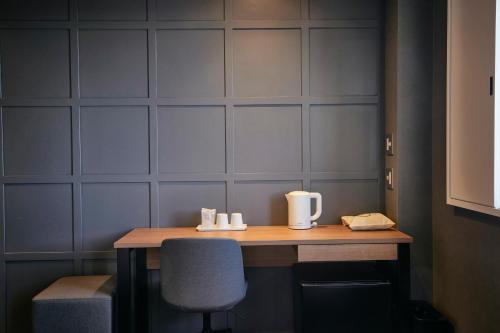 a table in a room with a chair and a table sidx sidx sidx at 3s HOTEL ATSUGI in Atsugi