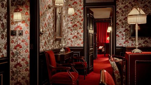 a hotel room with red chairs and a mirror at L'Escape Hotel in Seoul