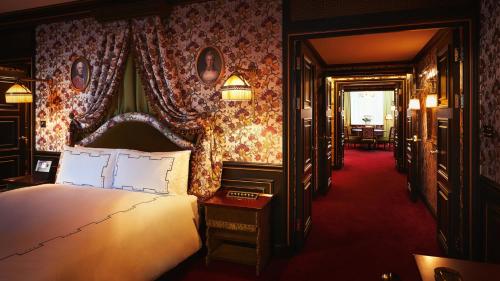a bedroom with a bed and a room with tables at L'Escape Hotel in Seoul