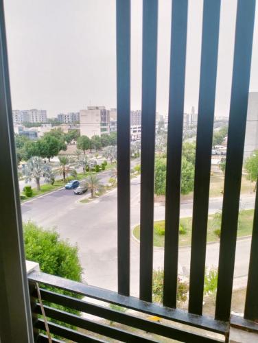 a window with a bench looking out at a parking lot at Com Heights Near Clock chowk bahria Town Lahore in Rāmkot