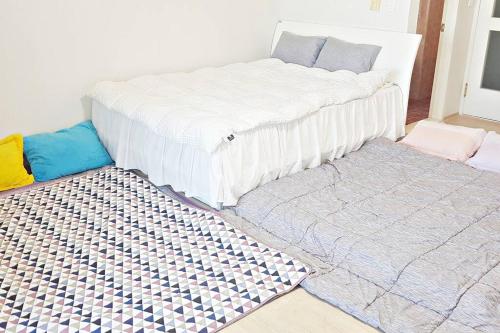 two mattresses sitting on the floor in a room at G-817 Gunsan Business and Leisure Trip, 5mins to Eunpa Park in Gunsan-si