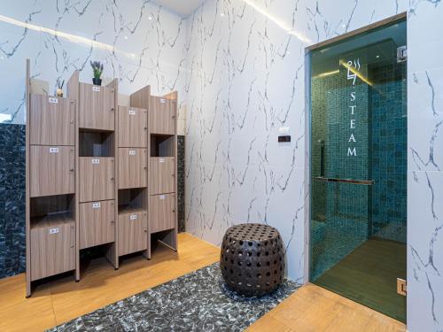 a room with wooden lockers and a glass door at Patong Bay Residence in Patong Beach