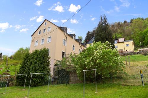a building with a soccer field in front of it at Apartment im Zentrum mit Stellplatz und Festungsblick in Königstein an der Elbe