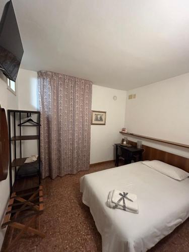 a hotel room with a bed and a window at Albergo da Pina in Lazise