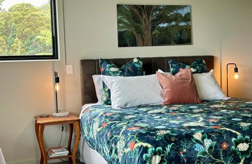 a bedroom with a bed with a colorful comforter at The Top Place Retreat in Caveside